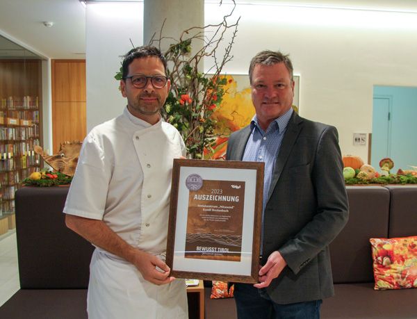 Bürgermeister Anton Hoflacher und Küchenchef Dietmar Trummer halten die Auszeichnung